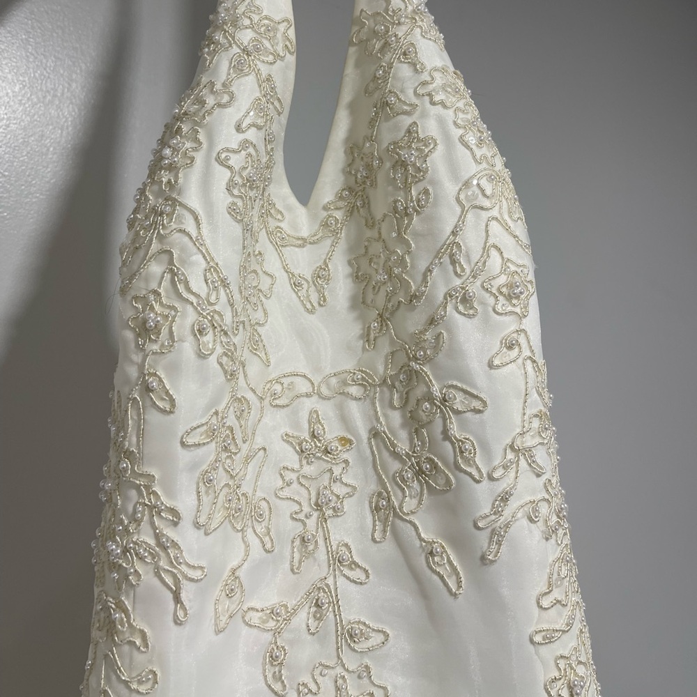 Ivory in color. Never worn except to try on. Size 12 has never been altered.